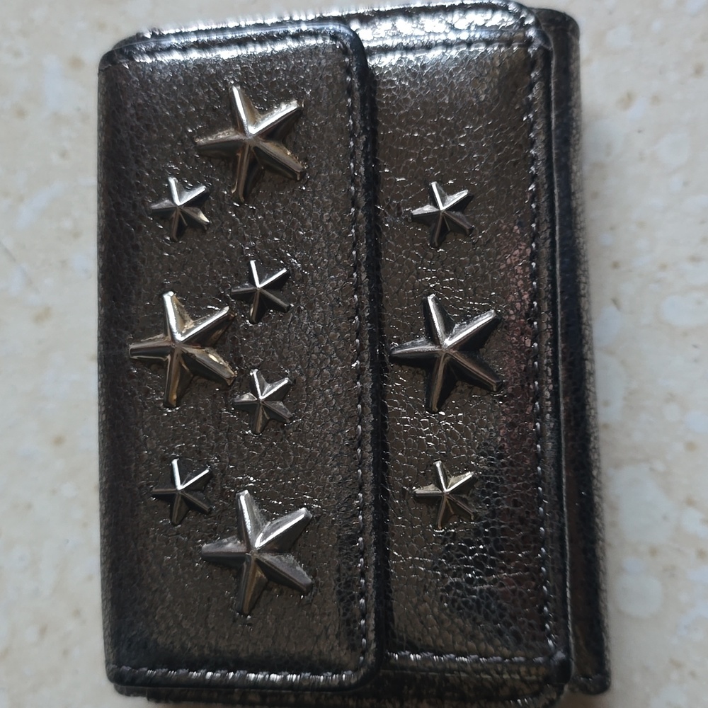 Jimmy Choo Nemo Tri-fold Wallet with star stud embellishments.
